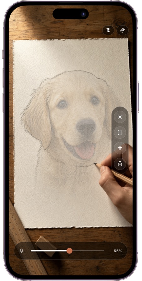 A phone running Tracely over paper, showing a puppy photo while a hand traces its outline in pencil